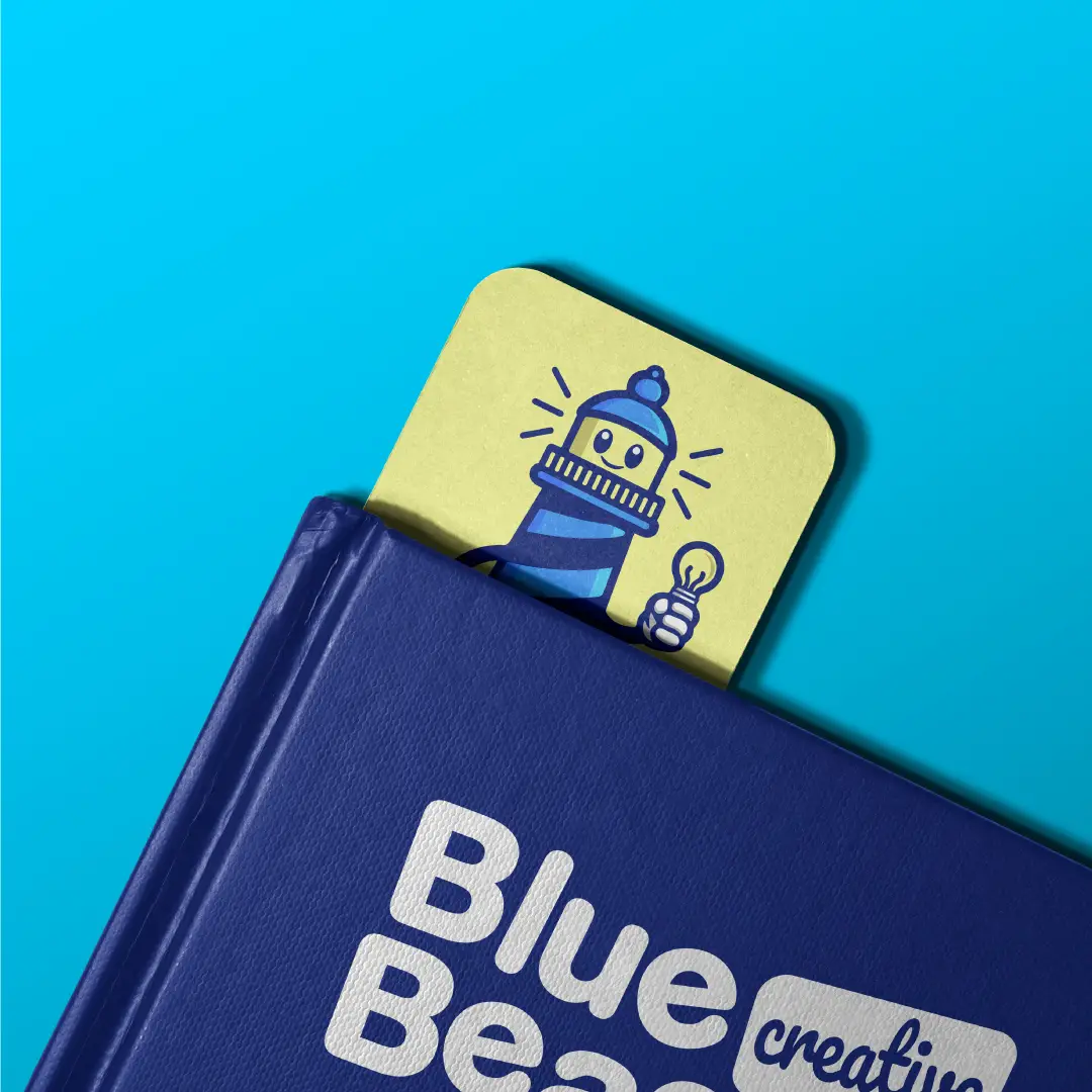 A branded bookmark for Blue Beacon, showcasing the lighthouse logo and vibrant blue and yellow colors.